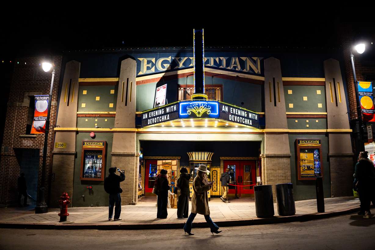People walk on Main Street outside the Egyptian Theater in Park City during the final Sundance Film Festival in Utah on Friday.