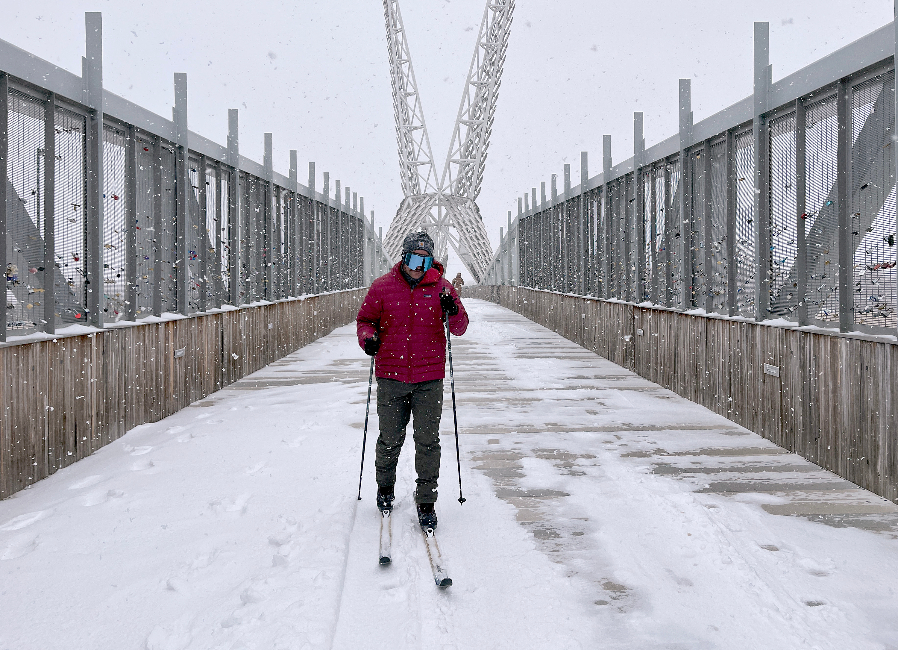 Jacob Coleman skis across SkyDance Bridge over Interstate 40 during a snowstorm in Oklahoma City on Saturday.