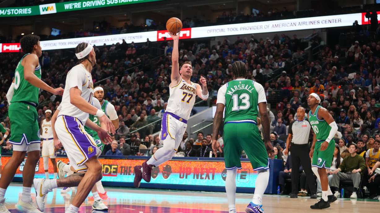 Los Angeles Lakers guard Luka Doncic (77) throws up a shot against Dallas Mavericks forward Naji Marshall (13) during the first half of an NBA basketball game Saturday, Jan. 24, 2026, in Dallas.