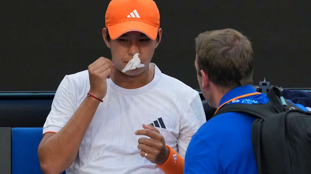 Learner Tien of the U.S. receives treatment for a nose bleed during his fourth round match against Daniil Medvedev of Russia at the Australian Open tennis championship in Melbourne, Australia, Sunday, Jan. 25, 2026.