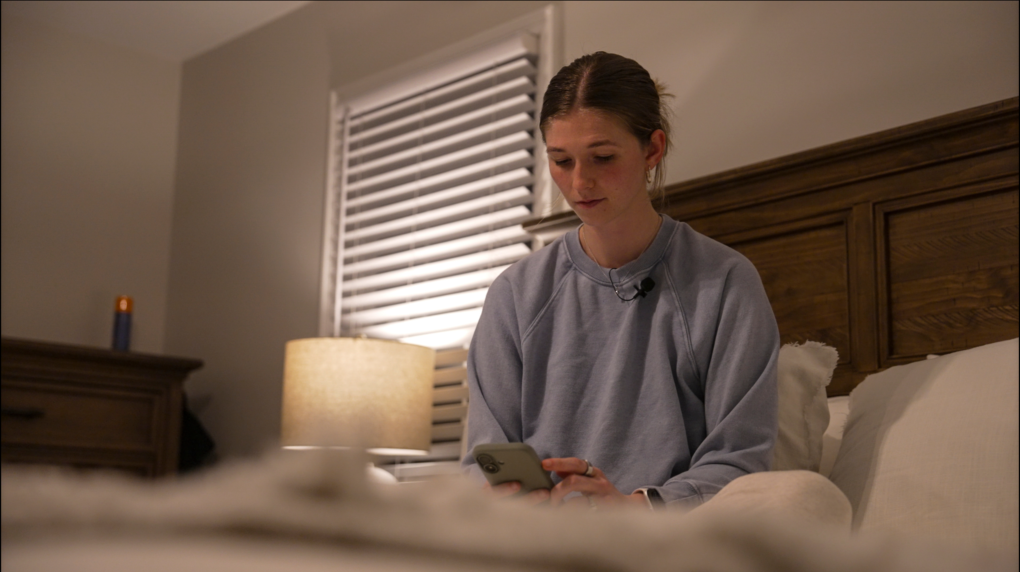 Middle school teacher Kate Stoye checks her sleep score on her phone, Jan. 7, in Hiram, Ga. Experts want users to know sleep trackers have limits.