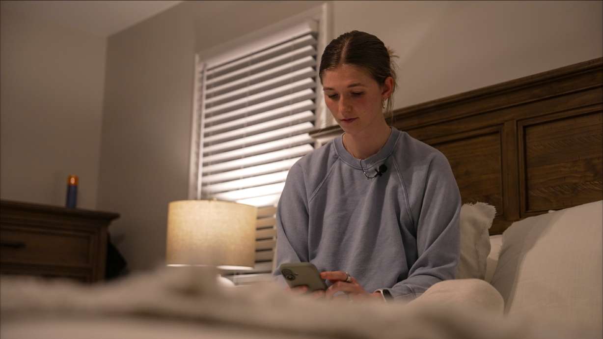 Middle school teacher Kate Stoye checks her sleep score on her phone, Jan. 7, in Hiram, Ga. Experts want users to know sleep trackers have limits.