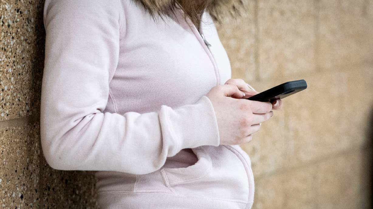 A student in a hallway at Olympus High School in Holladay on Jan. 8. People have grown comfortable turning to devices to reduce difficulty in their lives, which can drive them further from a sense of meaning, according to a Harvard professor.