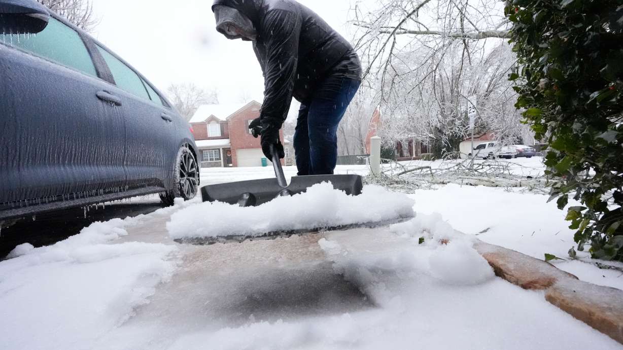 David Bentley shovels ice and snow from his driveway during a winter storm Sunday, Jan. 25, 2026, in Nashville, Tenn.