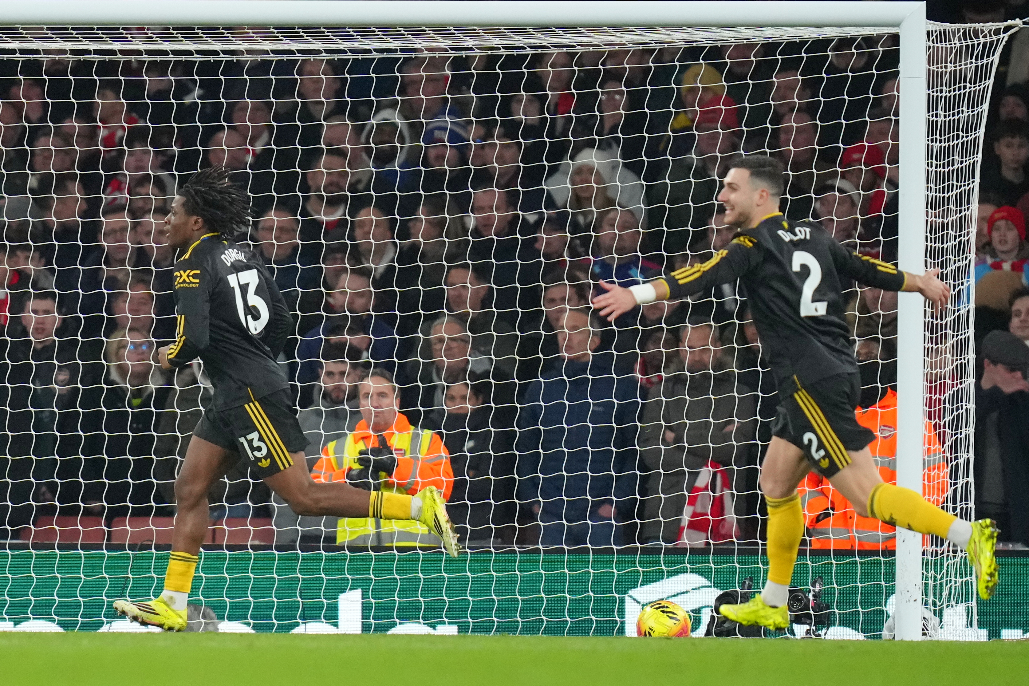 Manchester United's Patrick Dorgu, left, celebrates scoring his side's second goal during the English Premier League soccer match between Arsenal and Manchester United in London, Sunday, Jan. 25, 2026. 