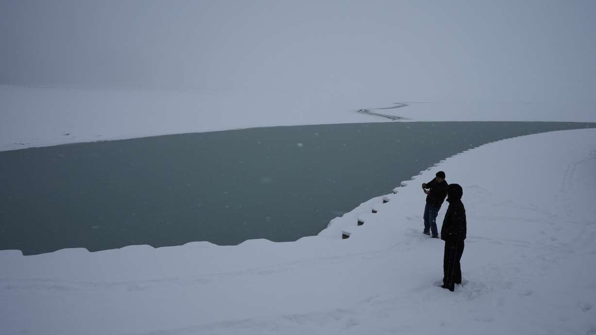 People take photos at Lake Michigan in Chicago, Sunday.