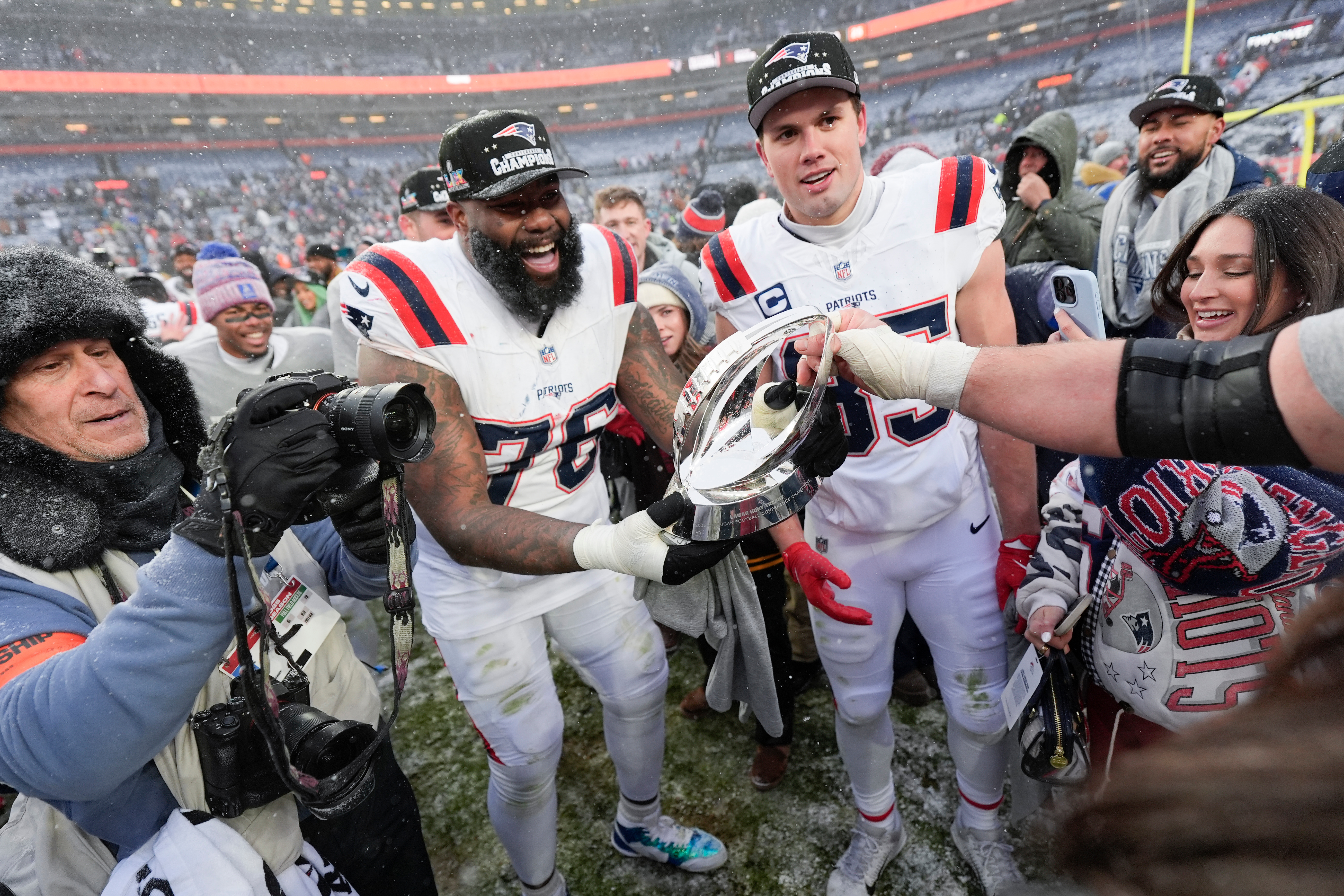 New England Patriots offensive tackle Morgan Moses (76) and tight end Hunter Henry celebrate after the AFC Championship NFL football game against the Denver Broncos, Sunday, Jan. 25, 2026, in Denver. 
