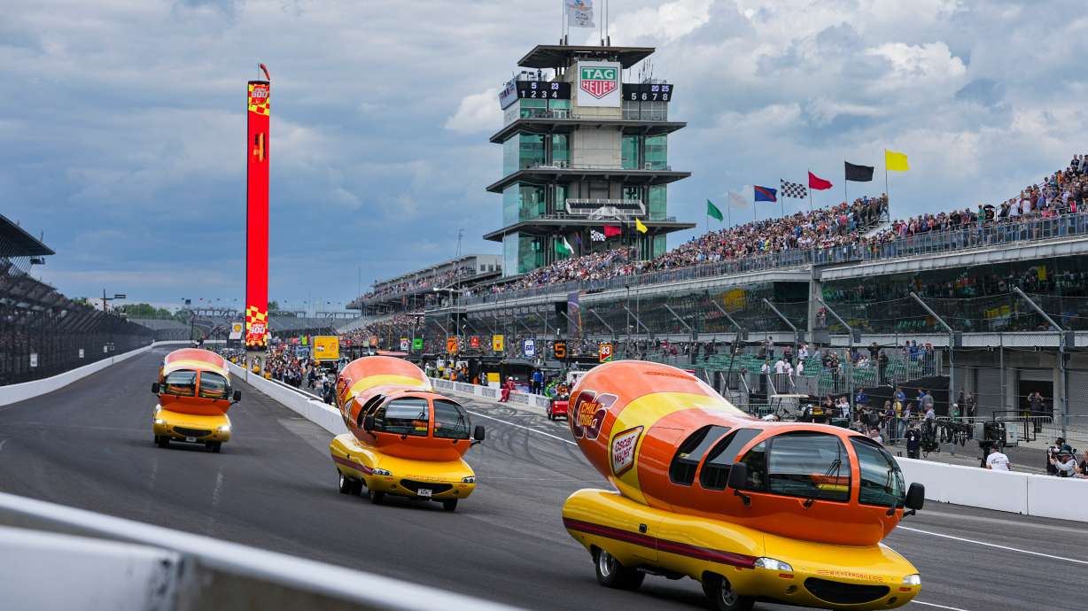 FILE - Oscar Mayer Wienermobiles head into the first turn as they compete in the Wienie 500 following the practice session for the Indianapolis 500 auto race at Indianapolis Motor Speedway in Indianapolis, May 23, 2025.