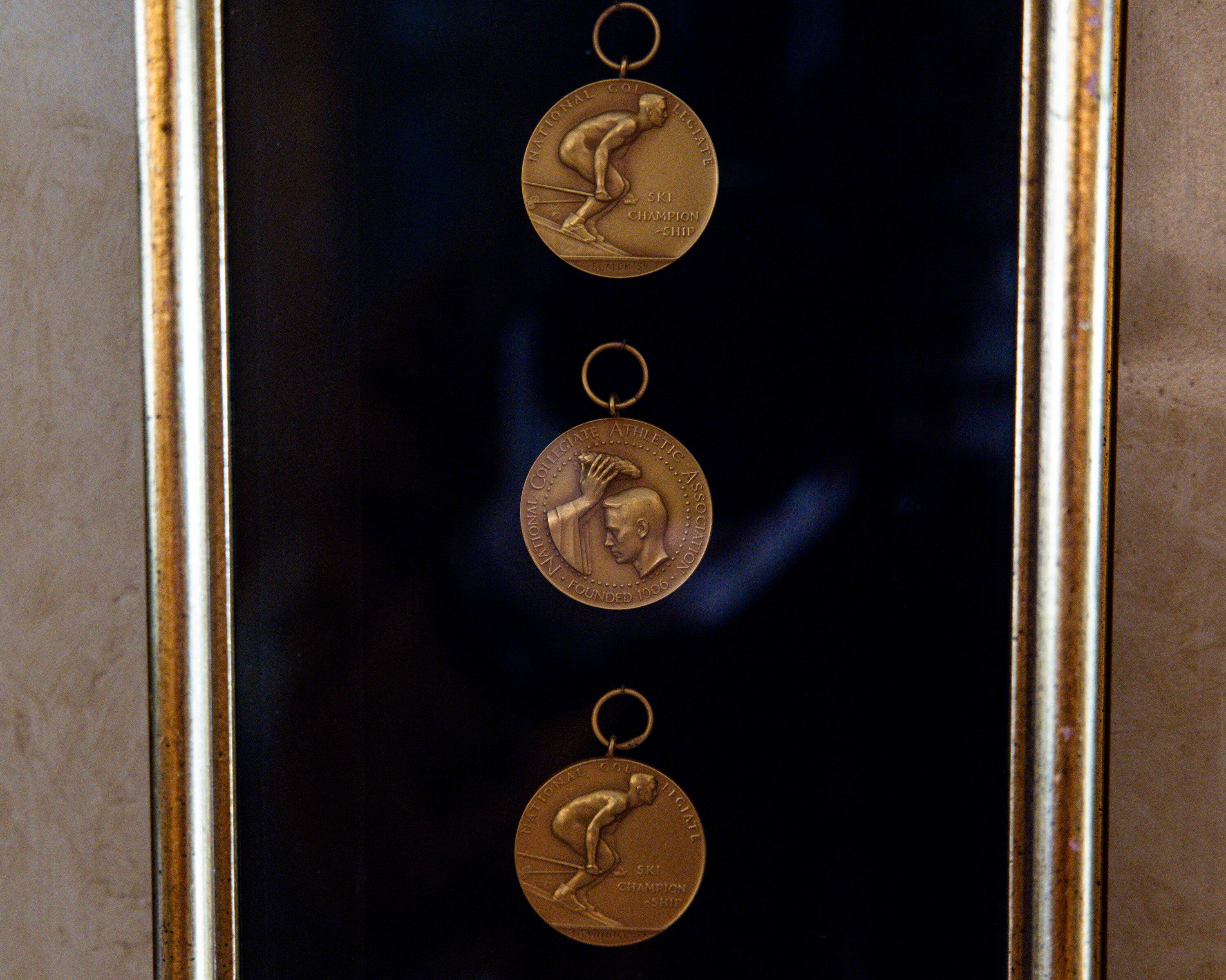 NCAA medals hang in a case near the door of Marvin Melville’s home in Cottonwood Heights on Dec. 15, 2025.