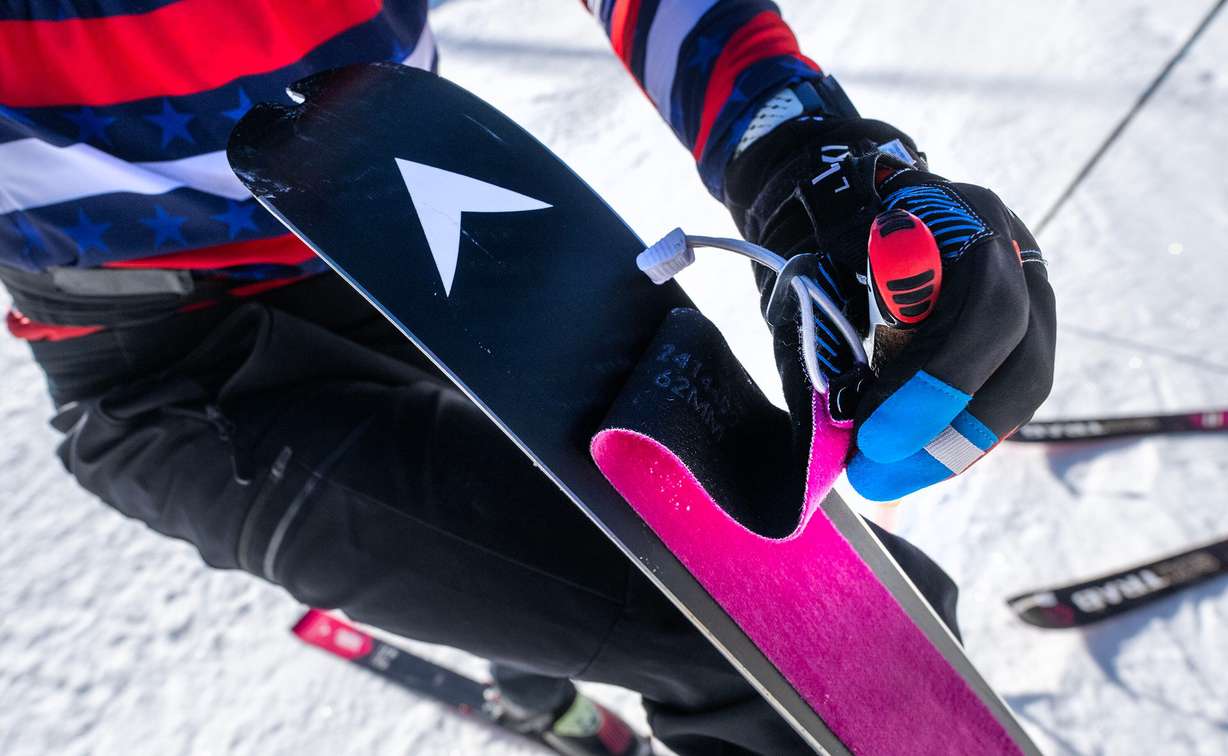 Skimo athlete Landon Jakob shows one of the skins, which are strips of fabric attached to ski bases to grip snow for climbing, as he and fellow teammate McCall Birkinshaw demonstrate the relatively new sport during a short workout in Alta on Tuesday.