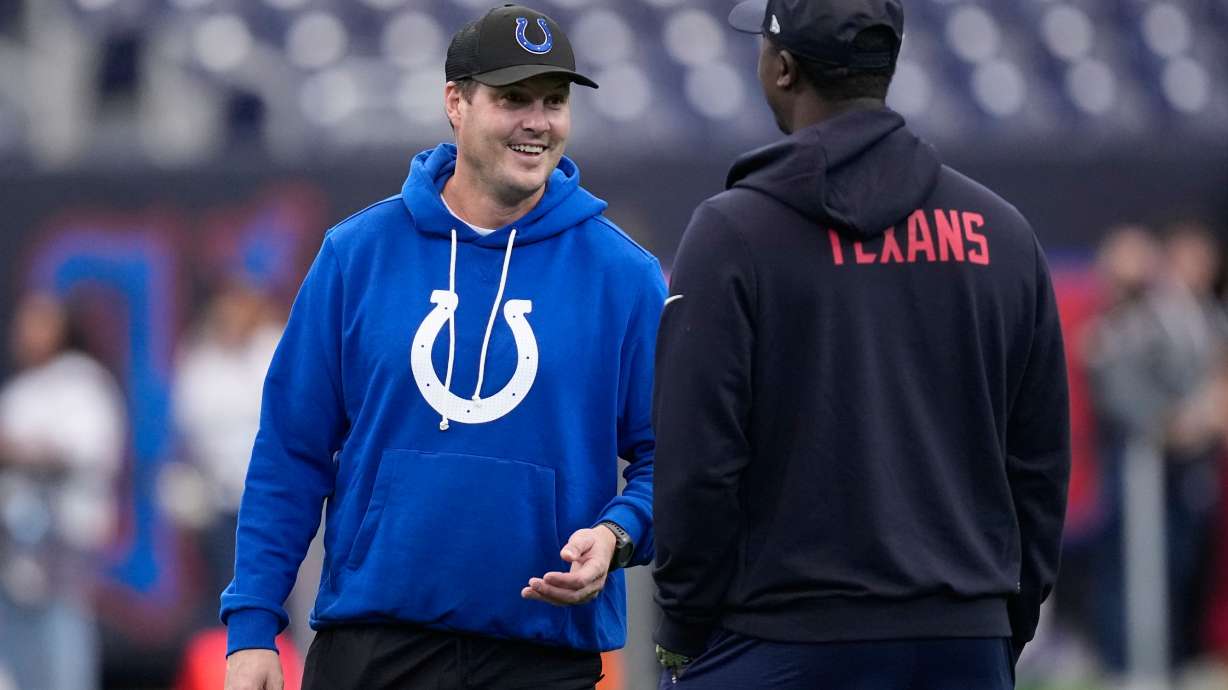 Indianapolis Colts quarterback Philip Rivers, left, visits before an NFL football game against the Houston Texans in Houston, Sunday, Jan. 4, 2026.