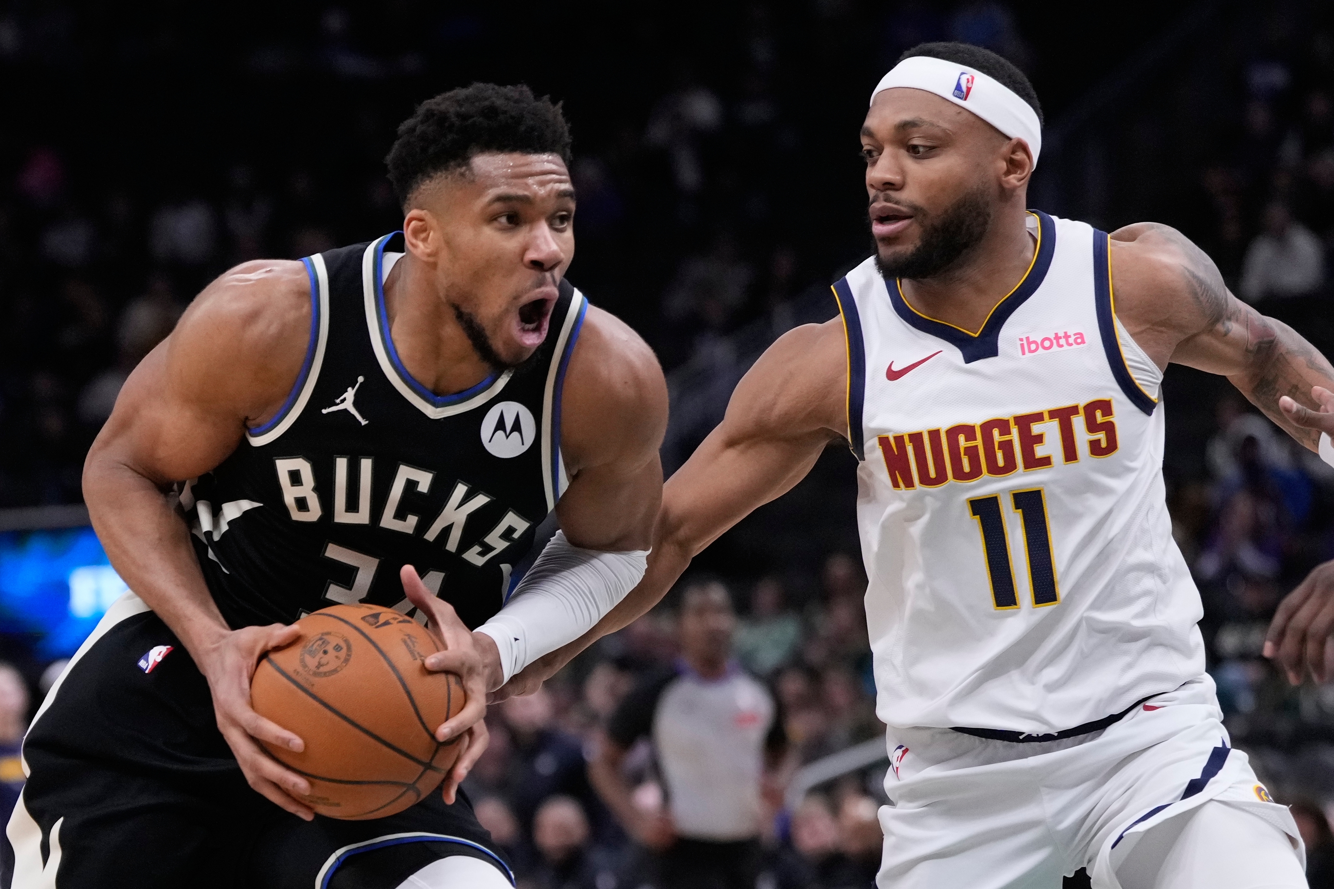 Milwaukee Bucks' Giannis Antetokounmpo tries to drive past Denver Nuggets' Bruce Brown during the second half of an NBA basketball game Friday, Jan. 23, 2026, in Milwaukee. 