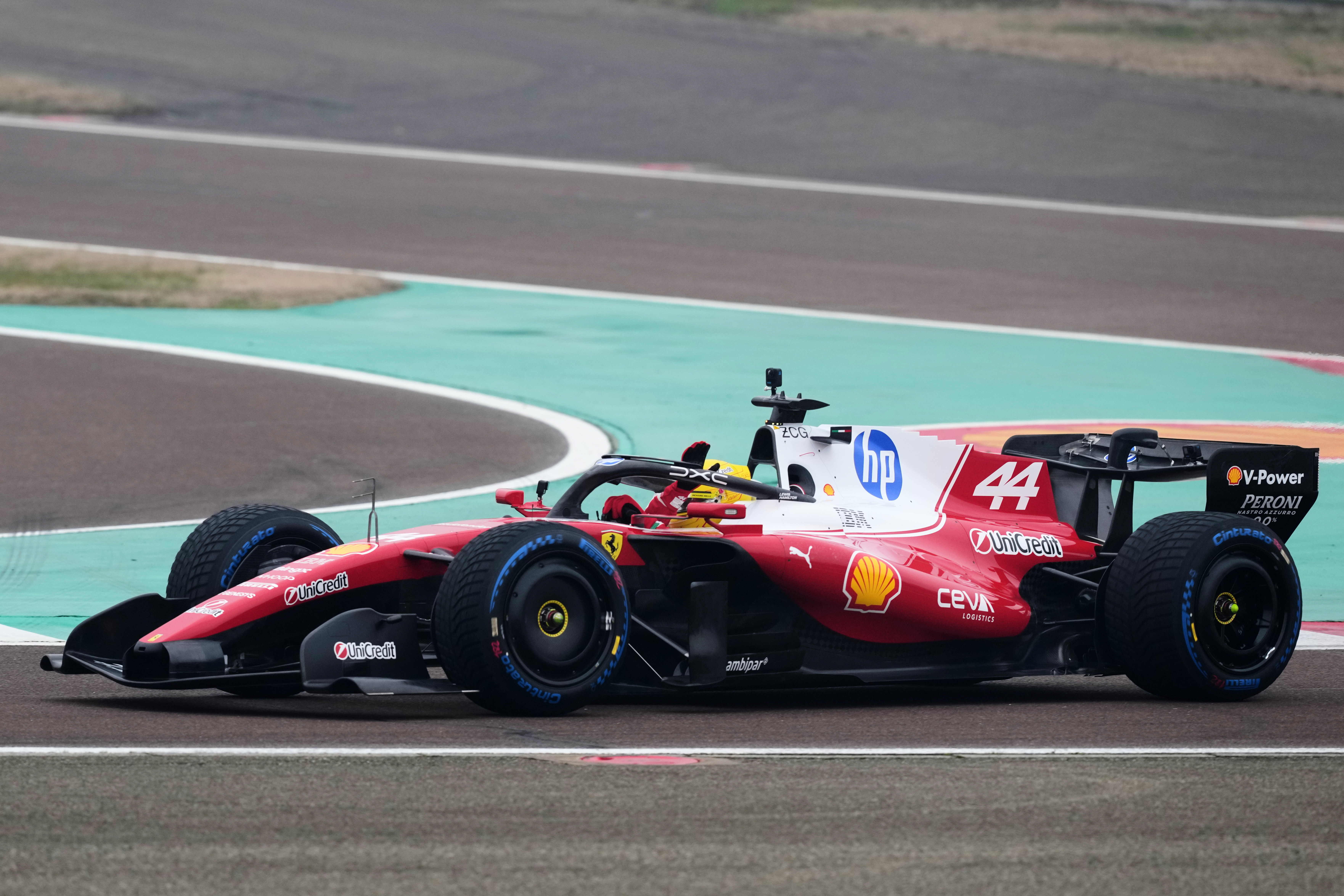 Britain's Lewis Hamilton waves to fans as he steers his Ferrari Formula One SF-26 at the Ferrari private test track, in Fiorano Modenese, Italy, Friday, Jan. 23, 2026. 