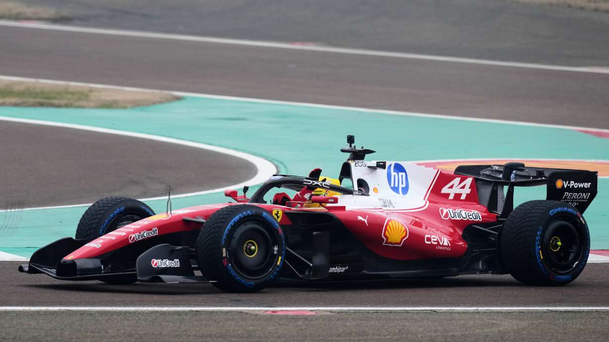 Britain's Lewis Hamilton waves to fans as he steers his Ferrari Formula One SF-26 at the Ferrari private test track, in Fiorano Modenese, Italy, Friday, Jan. 23, 2026.