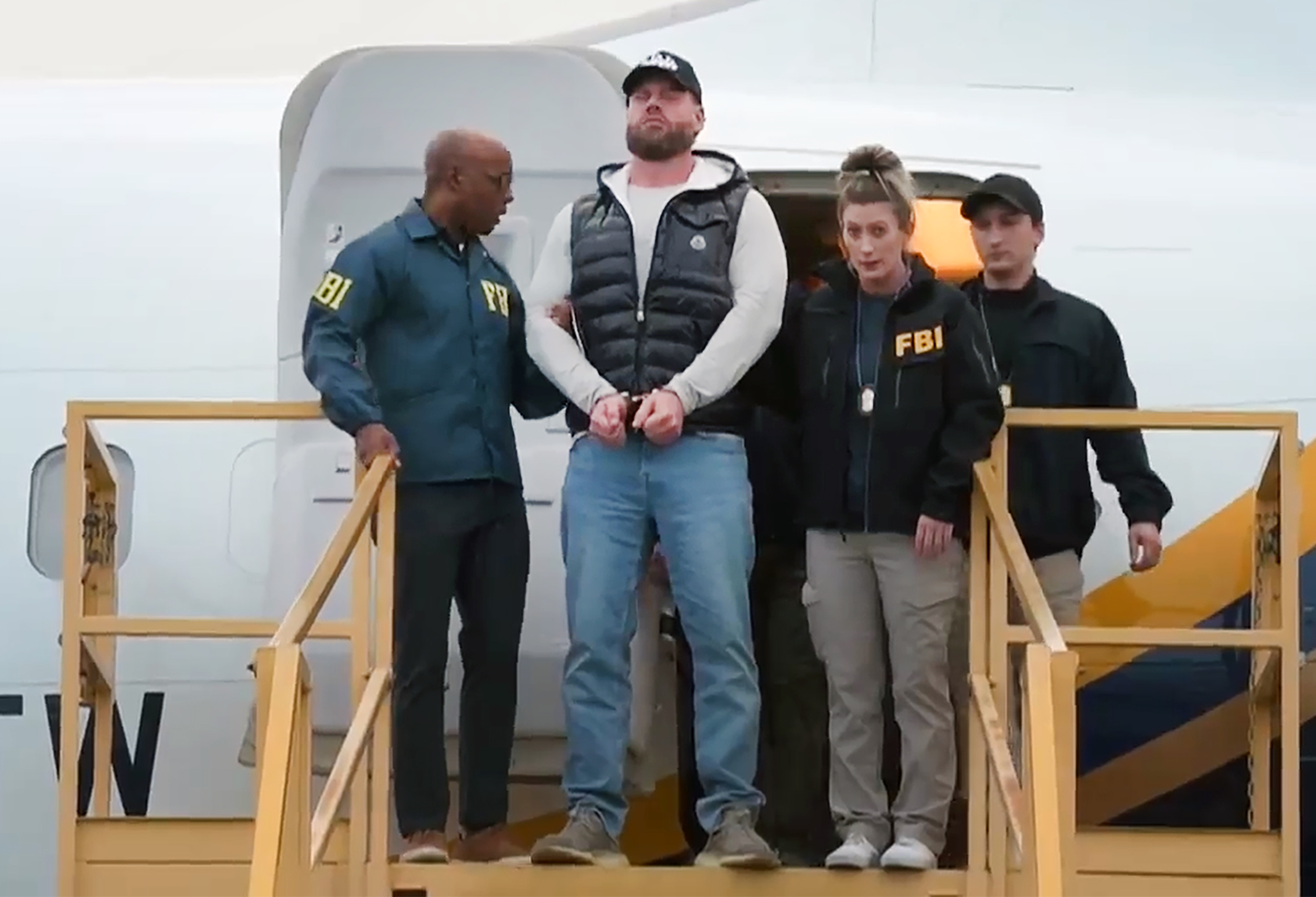 This still photo taken from video and provided by the FBI shows Ryan Wedding a former Canadian Olympic snowboarder facing charges related to drug trafficking and the killing of a federal witness is taken off a plane at Ontario International Airport in Ontario, Calif. on Friday, Jan. 23, 2026. 