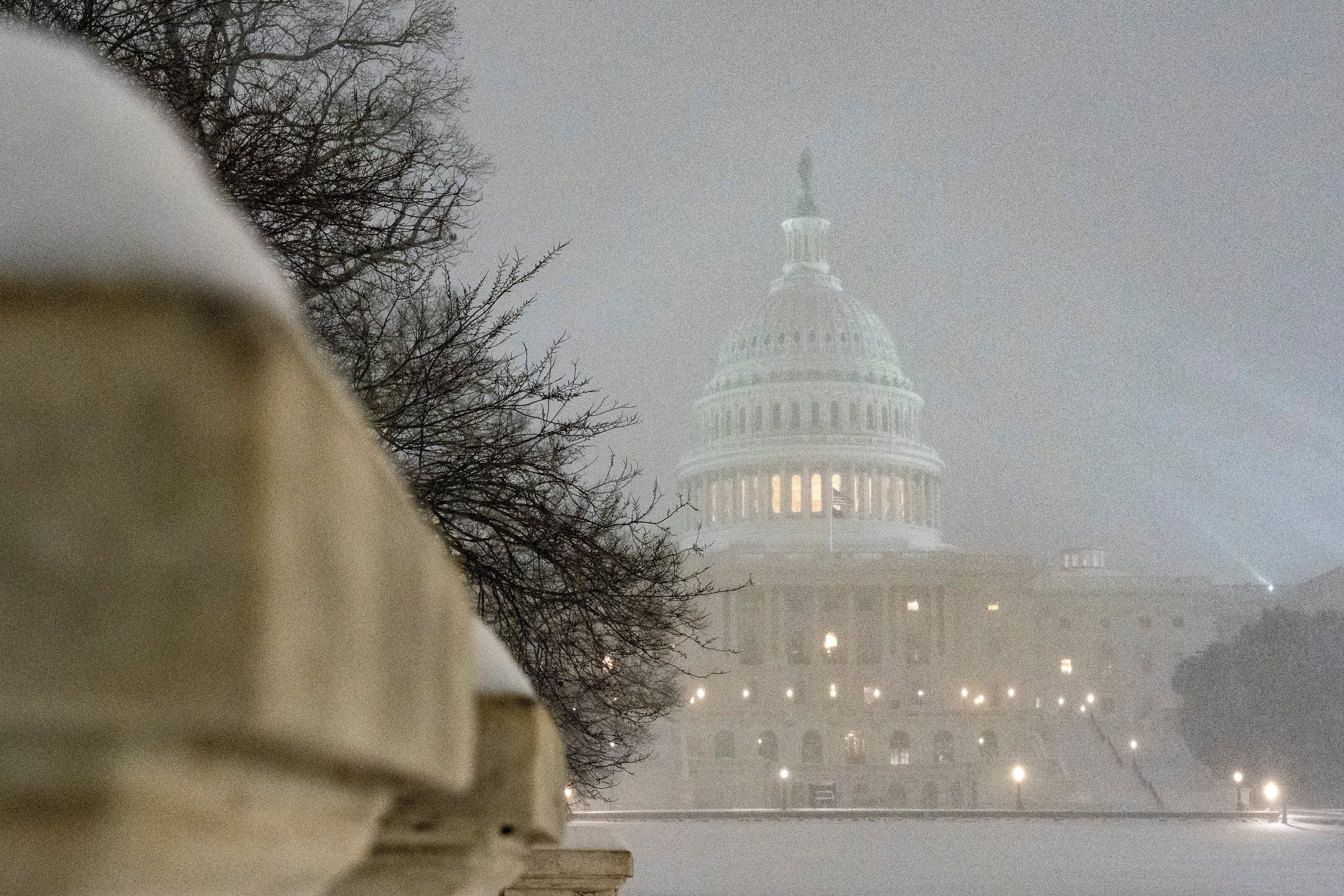 The U.S. Capitol is seen as snow falls, Sunday, in Washington.