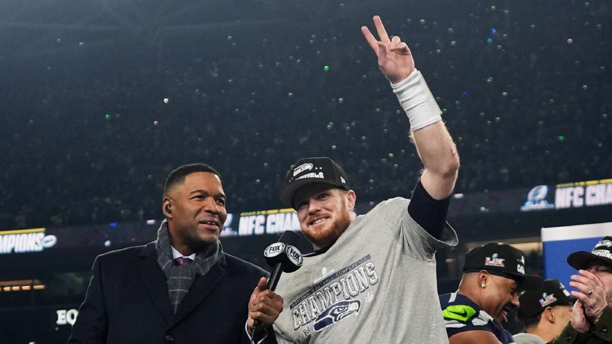 Seattle Seahawks quarterback Sam Darnold, celebrates next to Michael Strahan, left, after a win over the Los Angeles Rams in the NFC Championship NFL football game Sunday, Jan. 25, 2026, in Seattle.