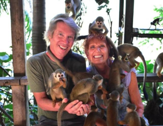 Alan Southern and his wife Cathy hold monkeys on a trip in the Dominican Republic.