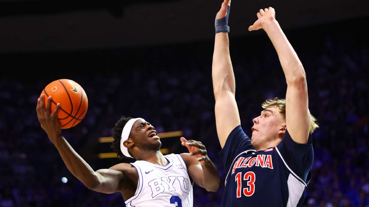 BYU forward AJ Dybantsa (3) drives to the basket against Arizona Wildcats center Motiejus Krivas (13) during the first half of an NCAA basketball game at the Marriott Center in Provo on Monday, Jan. 26, 2026.
