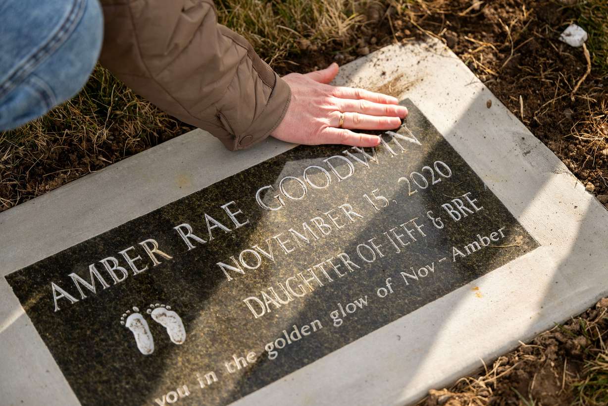 The gravesite of daughter Amber Rae Goodwin (November 2020). The Goodwins posed for photos in Bountiful on Saturday. They lost two babies within hours of their births after both were born with no kidneys. They were told it wouldn't happen twice.