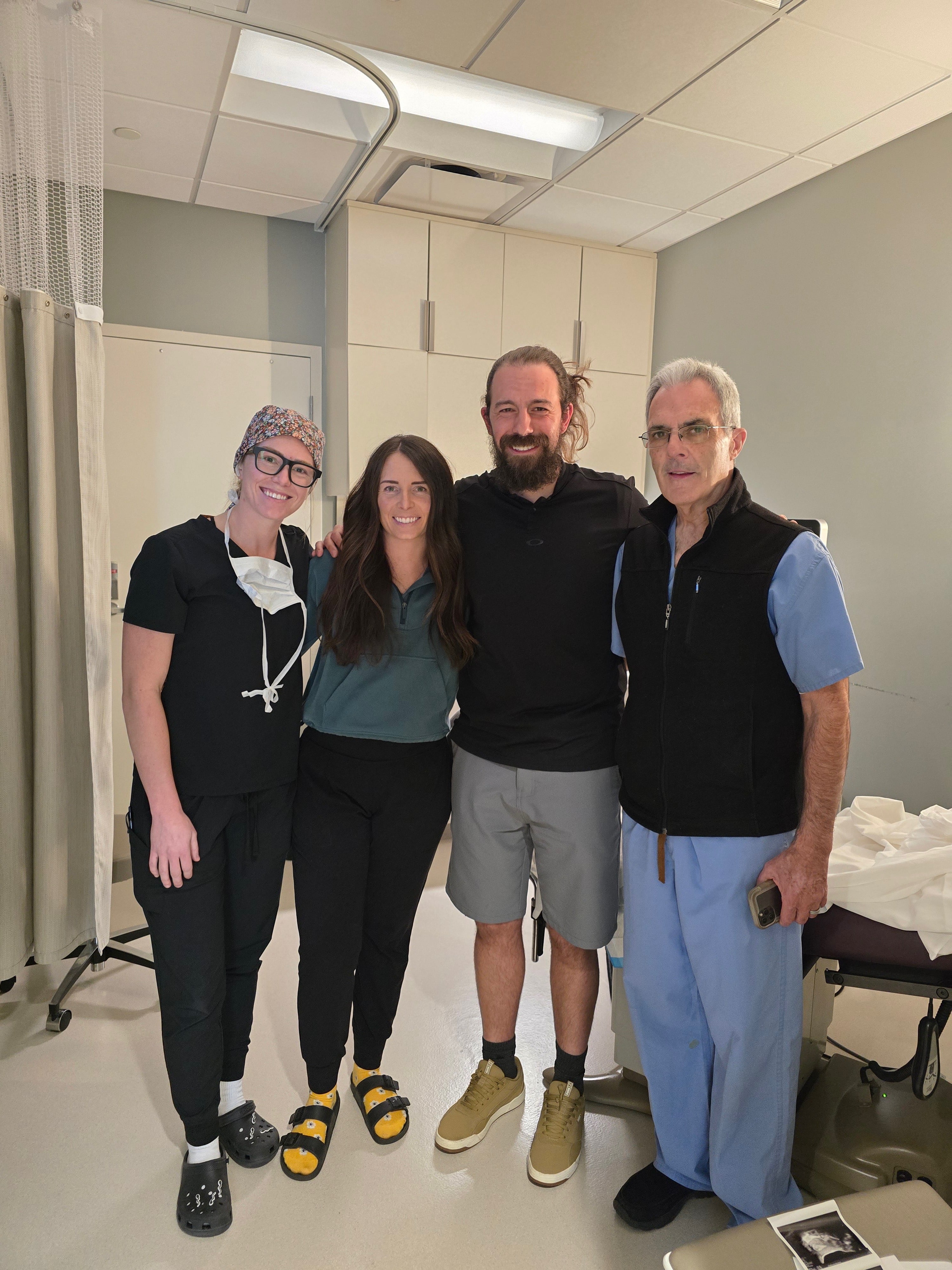 From left, Embryologist Shelby Osborne, Bre Goodwin, Jeff Goodwin and Dr. Matt Peterson pose for a photo on the day of the embryo transfer at the Utah Fertility Center in Pleasant Grove on April 25, 2025.