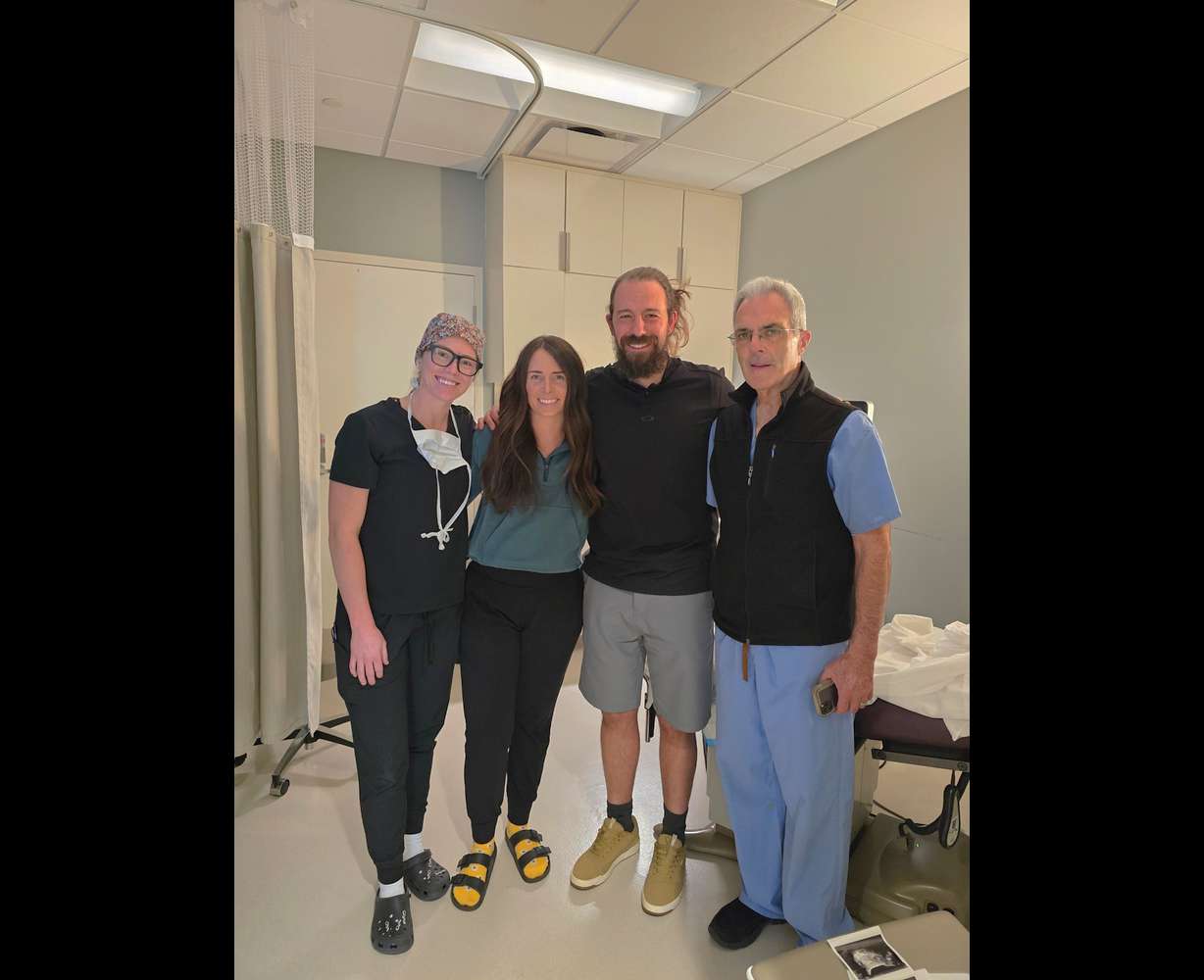 From left, Embryologist Shelby Osborne, Bre Goodwin, Jeff Goodwin and Dr. Matt Peterson pose for a photo on the day of the embryo transfer at the Utah Fertility Center in Pleasant Grove on April 25, 2025.