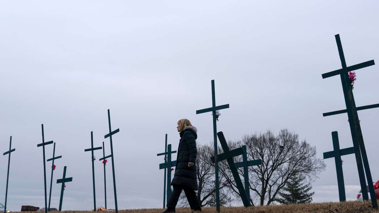 Crosses are seen at a makeshift memorial for the victims of the plane crash in the Potomac River near Ronald Reagan Washington National Airport, Jan. 31, 2025, in Arlington, Va. A hearing is underway to highlight what led to that deadly crash.