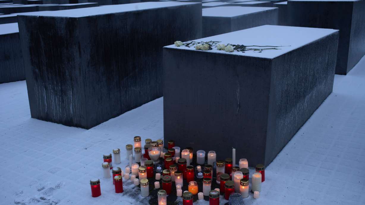 Candles placed in front of a concrete slab of the Holocaust memorial to mark the International Holocaust Memorial Day in Berlin, Germany, Tuesday. People across Europe paused to commemorate International Holocaust Remembrance Day.