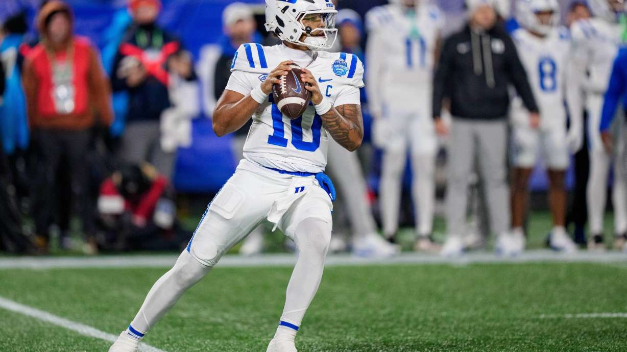 FILE - Duke quarterback Darian Mensah (10) drops back to pass during the Atlantic Coast Conference championship NCAA college football game between Virginia and Duke, Dec. 6, 2025, in Charlotte, N.C.