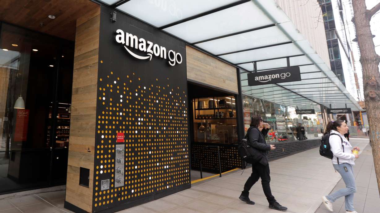 People walk out of an Amazon Go store in Seattle, Wash., March 4, 2020. Amazon announced Tuesday it would be shutting its Amazon Go and Amazon Fresh locations to concentrate its focus on grocery delivery, among other objectives.