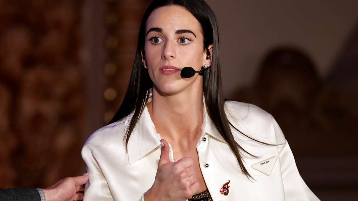 FILE - Indiana Fever's Caitlin Clark reacts during an interview during the WNBA basketball draft, April 15, 2024, in New York.