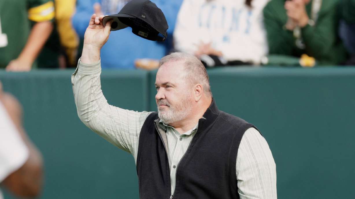 FILE - Former Green Bay Packers head coach Mike McCarthy waves during halftime of an NFL football game against the Detroit Lions Sunday, Sept. 7, 2025, in Green Bay, Wis.
