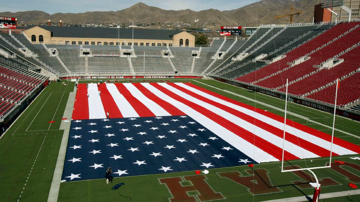 People work on a giant American flag on the field of Rice-Eccles Stadium at the University of Utah in Salt Lake City on March 16, 2007. The school launched a special presidential initiative on federalism and American governance this week.