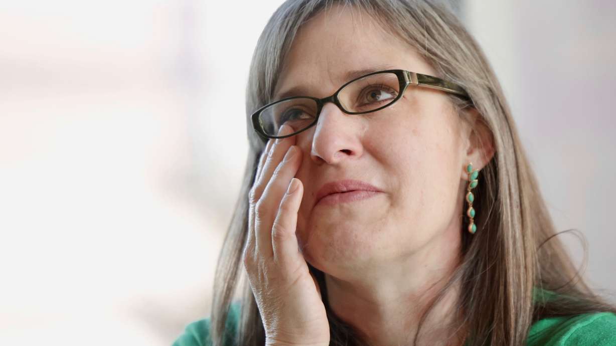 Heart transplant recipient Erin Barker gets emotional during an event celebrating the Intermountain Health Transplant Program surpassing 500 organ transplants in Murray on Tuesday.