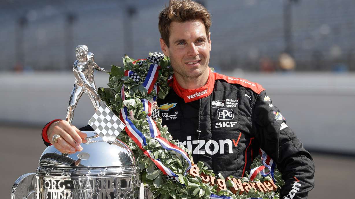 FILE Indianapolis 500 champion Will Power, of Australia, poses with the Borg-Warner Trophy during the traditional winners photo session on the start/finish line at the Indianapolis Motor Speedway, May 28, 2018, in Indianapolis.