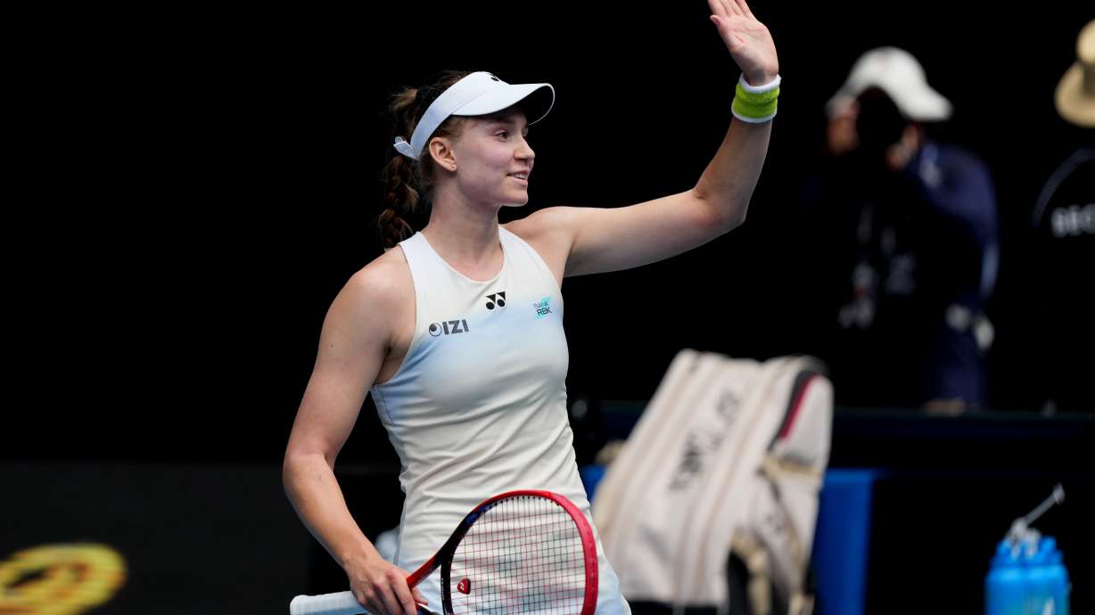 Elena Rybakina of Kazakhstan waves after defeating Iga Swiatek of Poland in their quarterfinal match at the Australian Open tennis championship in Melbourne, Australia, Wednesday, Jan. 28, 2026.