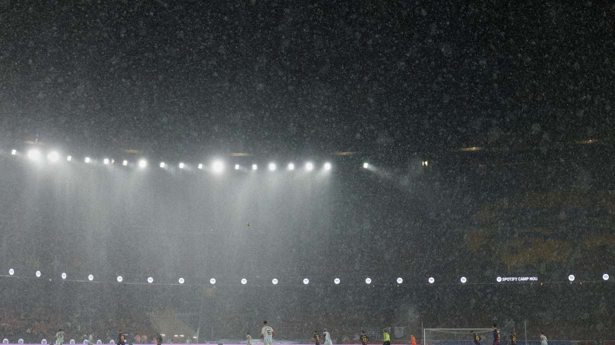 A heavy rain falls on the field during a Spanish La Liga soccer match between Barcelona and Real Oviedo in Barcelona, Spain, Sunday, Jan. 25, 2026.