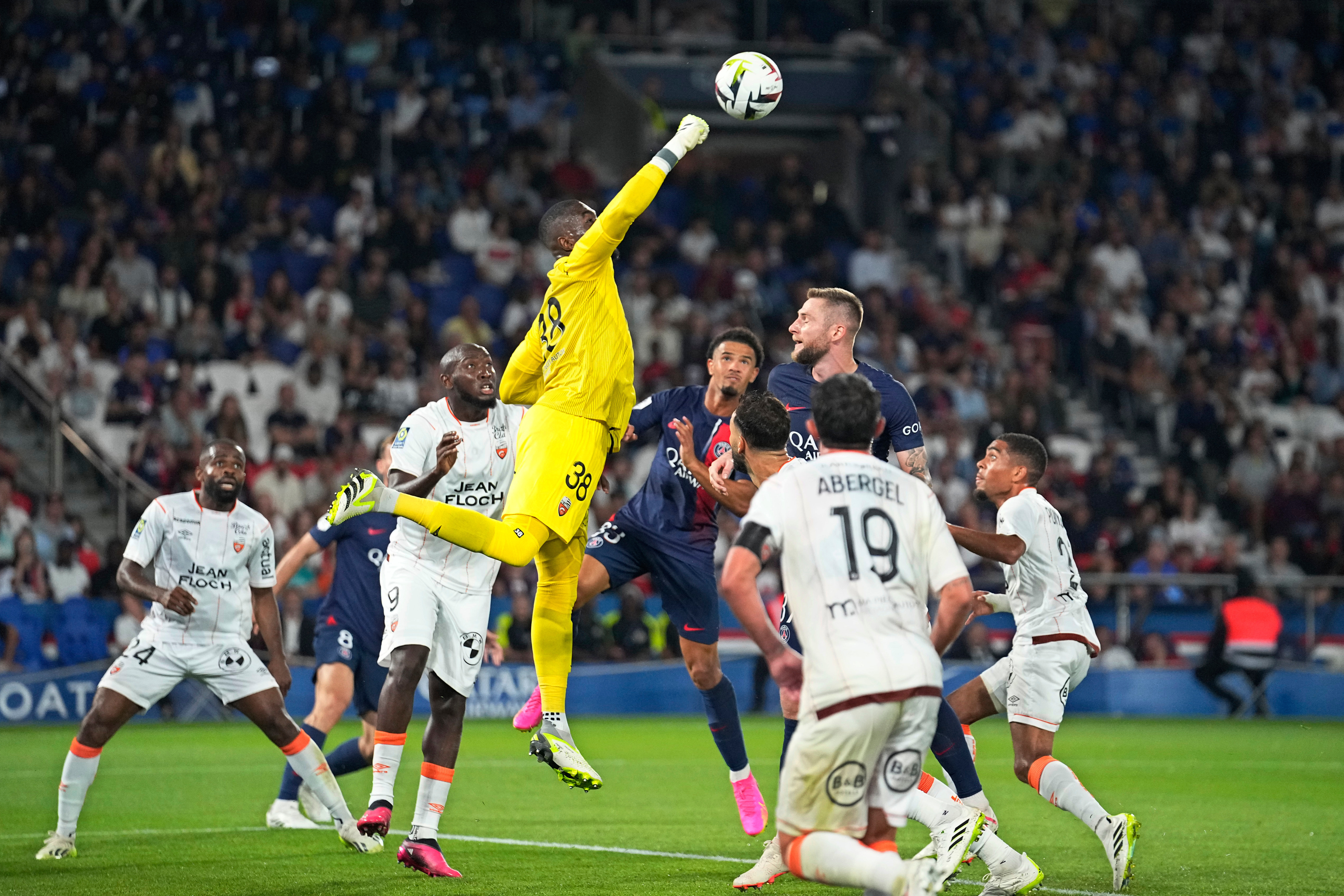 FILE - Lorient's goalkeeper Yvon-Lamdry Mvogo punches the ball clear during the French League One soccer match between Paris Saint-Germain and Lorient at the Parc des Princes stadium in Paris, Aug. 12, 2023. 