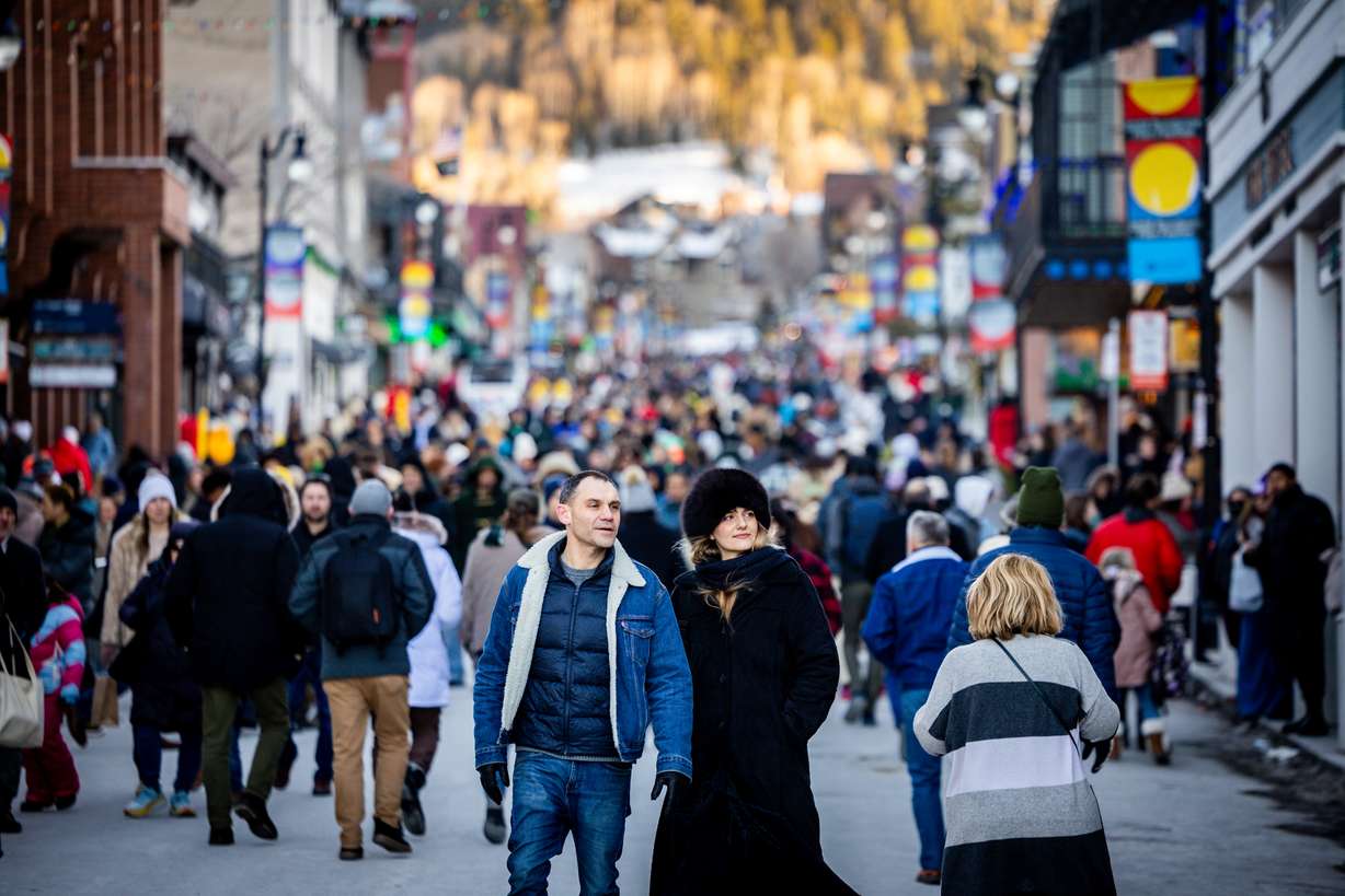 People walk on Main Street in Park City during the final Sundance Film Festival in Utah on Saturday.