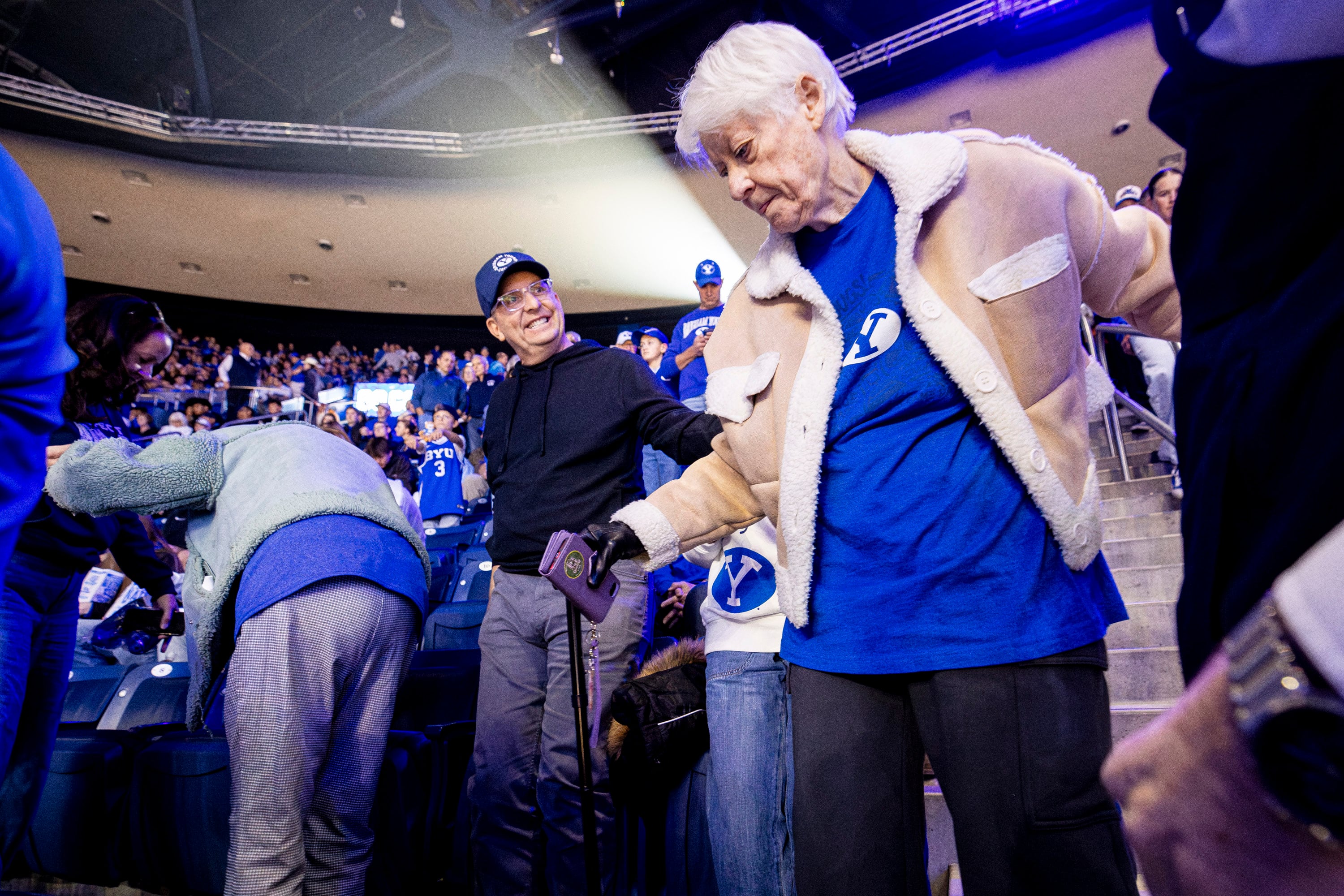 Chris Hammond, of Provo, smiles at Dixie Grimmett, 89, right, as he and fellow fans help her and her sister, Penny Spresser, 86, center left, to their seats before an NCAA men’s basketball game between BYU and Utah held at the Marriott Center in Provo on Jan. 24.