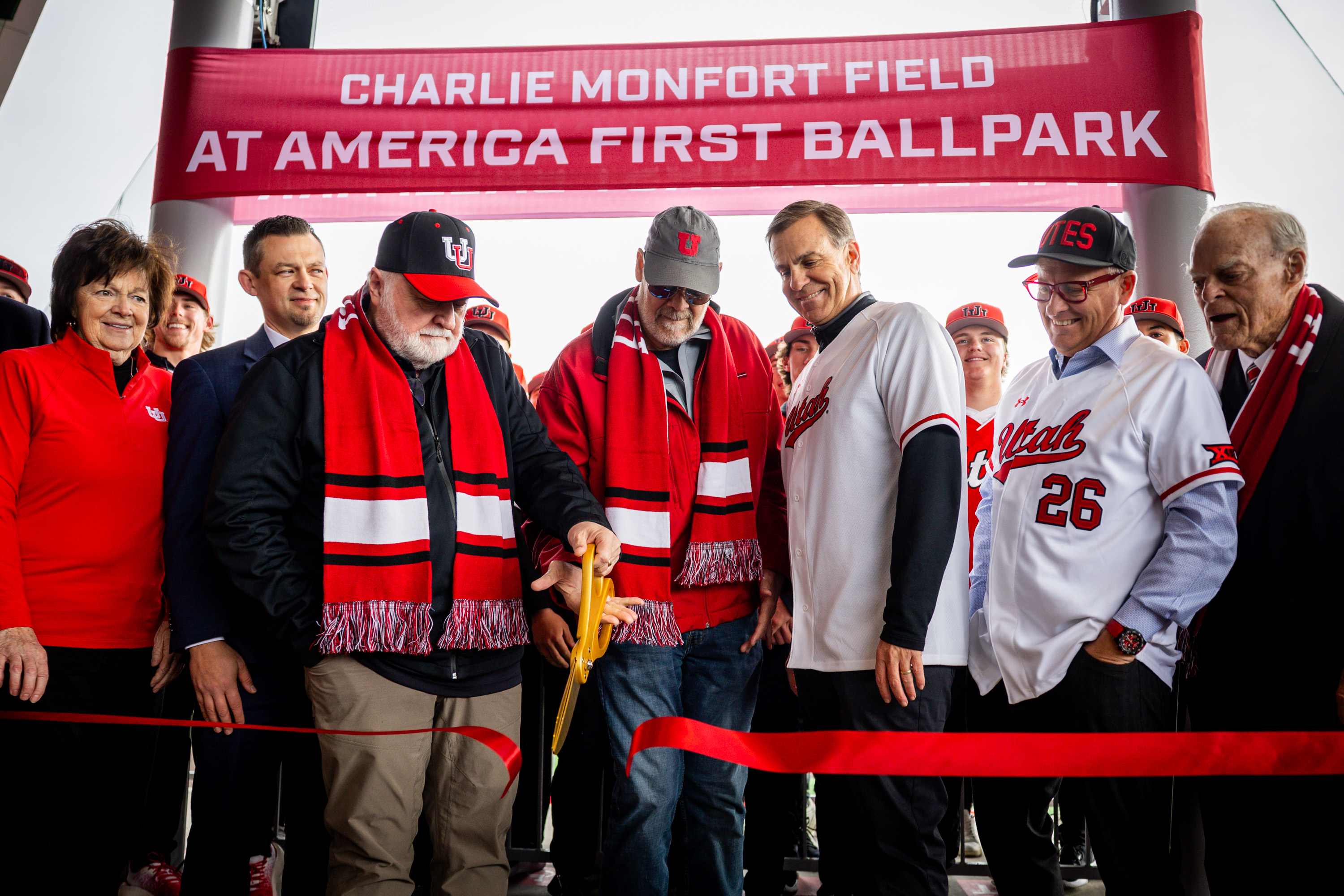 Thayne Shaffer, president and CEO of America First Credit Union, center left, and Charlie Monfort, center right, cut the ribbon during the Charlie Monfort Field at America First Ballpark grand opening and ribbon-cutting ceremony  in Salt Lake City on Wednesday, Jan. 28, 2026.