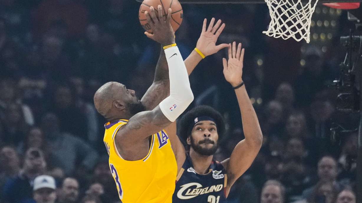 Los Angeles Lakers forward LeBron James left, shoots over Cleveland Cavaliers center Jarrett Allen (31) in the first half of an NBA basketball game in Cleveland, Wednesday, Jan. 28, 2026.