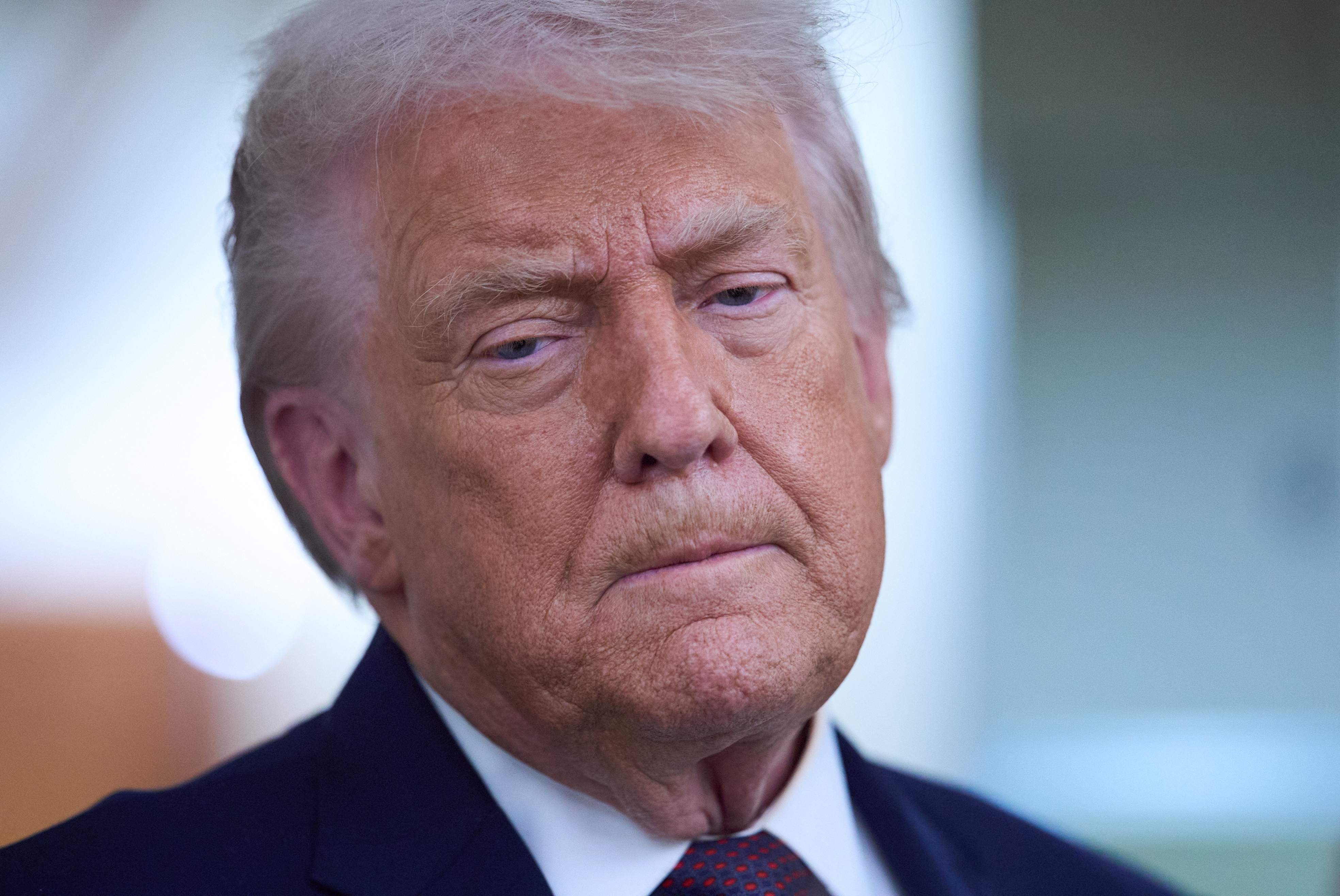 President Donald Trump speaks with reporters aboard Air Force One after leaving the World Economic Forum in Davos for Washington, Thursday, Jan. 22, 2026. 