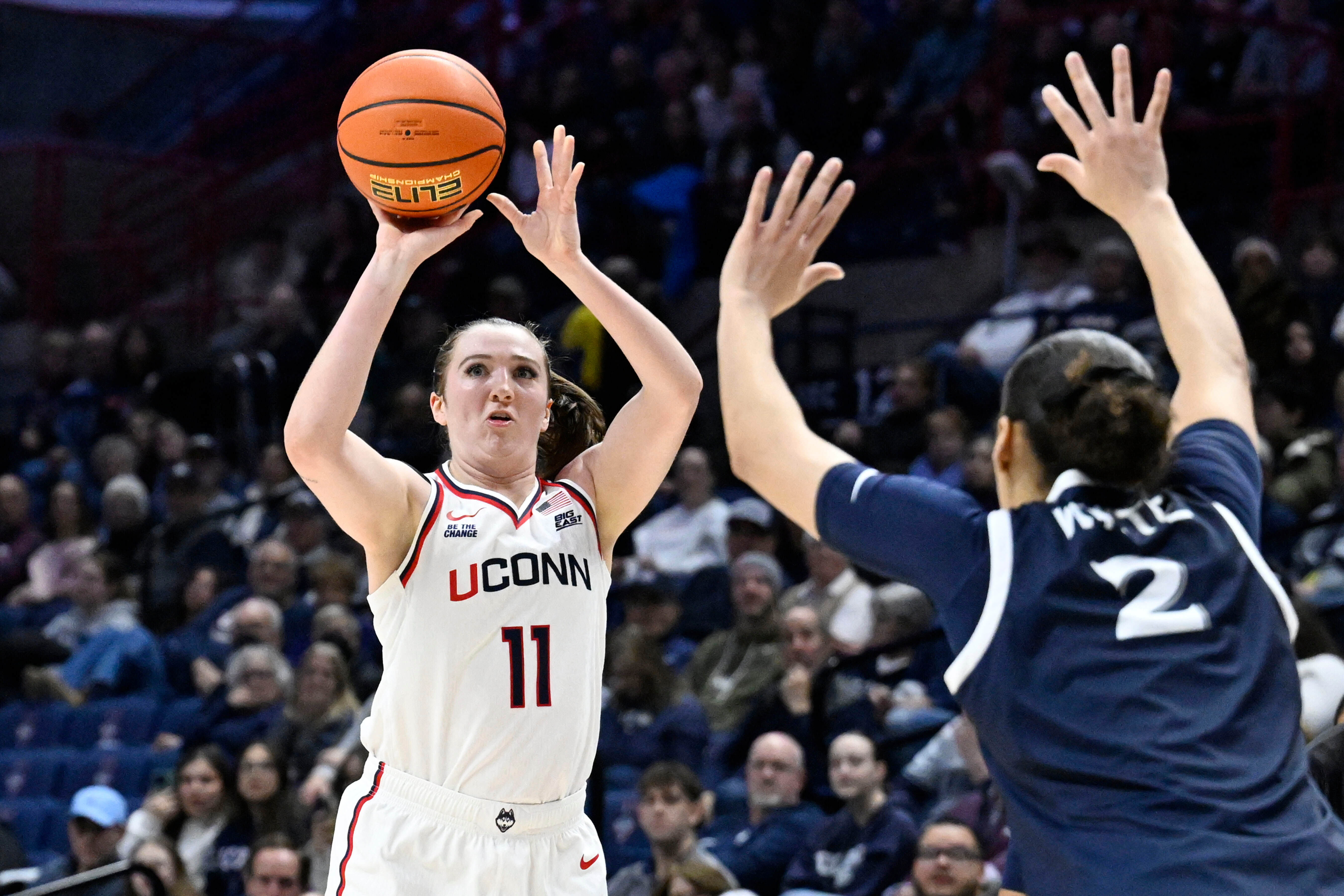 UConn guard Allie Ziebell (11) shoots as Xavier guard Savannah White (2) defends in the first half of an NCAA college basketball game, Wednesday, Jan. 28, 2026, in Storrs, Conn. 