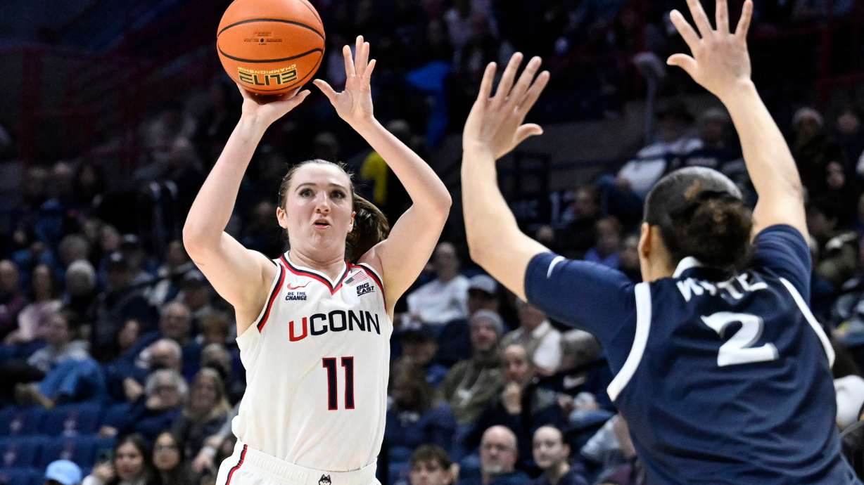 UConn guard Allie Ziebell (11) shoots as Xavier guard Savannah White (2) defends in the first half of an NCAA college basketball game, Wednesday, Jan. 28, 2026, in Storrs, Conn.