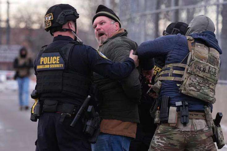 Law enforcement detain a man outside the Bishop Henry Whipple Federal Building during a protest on Jan. 17, 2026, in Minneapolis.