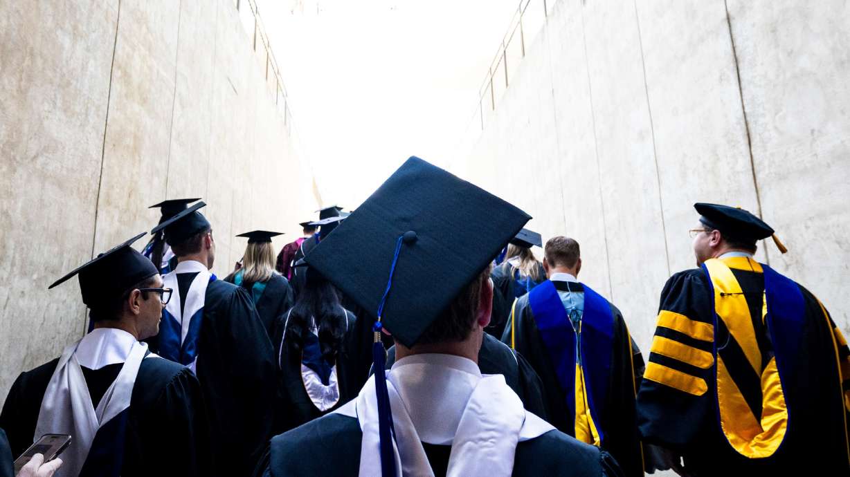 Graduates exit after Brigham Young University’s commencement ceremony at the Marriott Center in Provo on April 24, 2025.