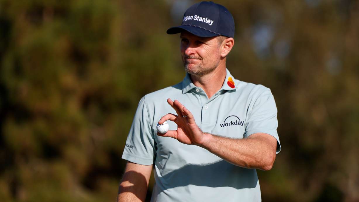 Justin Rose, of England, waves after finishing on the eighth hole on the North Course at Torrey Pines during the first round of the Farmers Insurance Open golf tournament Thursday, Jan. 29, 2026, in San Diego.