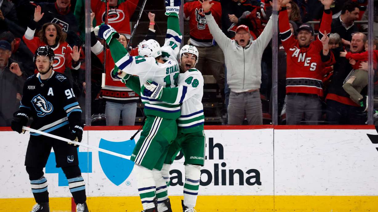 Carolina Hurricanes' Jordan Staal (11) is celebrates after his winning goal with teammate Jordan Martinook (48) with Utah Mammoth's Mikhail Sergachev (98) nearby during the third period of an NHL hockey game in Raleigh, N.C., Thursday, Jan. 29, 2026.