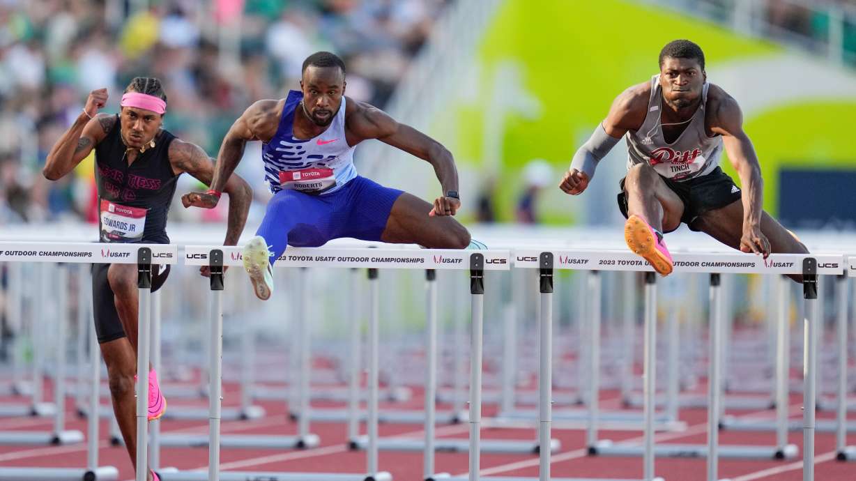FILE - Daniel Roberts and Cordell Tinch compete in the men's 110 meter hurdles semifinal during the U.S. track and field championships in Eugene, Ore., Sunday, July 9, 2023. Left is Eric Edwards.